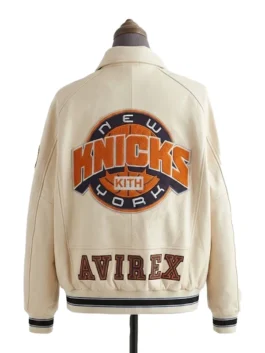 Rear view of a sportswear-inspired jacket featuring an oversized circular basketball patch and bold lower-back lettering.