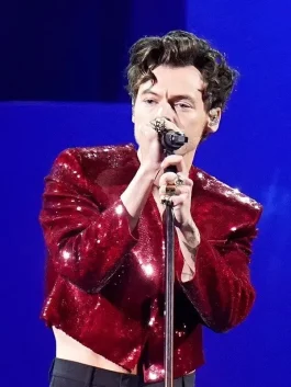 Harry Styles Brit Awards 2023 red sequin jacket with a glitter finish and bold party look.