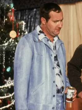 Randy Quaid wearing powder blue leisure suit near Christmas tree in holiday scene