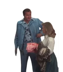 Randy Quaid wearing Cousin Eddie blue leisure suit beside Christmas gift scene