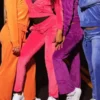 Close-up detail of Cheetah Girls velvet tracksuit costumes in orange, pink, purple and blue showing zip-up hoodie and wide-leg pants at J4Jackets