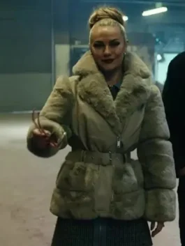 Chanel Cresswell in her oversized fur jacket from The Gentlemen, a bold statement fur jacket look with a belted waist and high hairstyle.