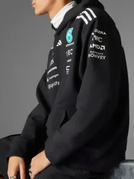 Close-up side view of the black Adidas x Mercedes F1 racing hoodie for men, showing sleeve and chest sponsor details.