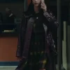 Scodelario Leather Coat The Gentlemen 2024 leather outfit showing a long purple trench coat over a plaid dress. Kaya Scodelario belted leather coat The Gentlemen.