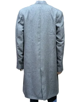 A full-length view of a gray suiting fabric trench coat featuring a lapel style collar and button front closure on a mannequin.