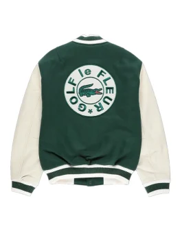 Tyler the Creator green varsity jacket and fur hat giving a speech on stage. Golf le Fleur style.