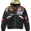 Vetements x Alpha Industries Hooded Racing Jacket in black with multicolored patches and a graphic hooded collar.
