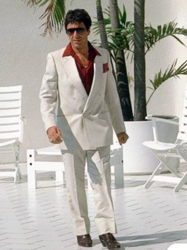 Tony Montana Scarface white suit close-up with intense expression, showing the red Suit