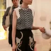 Lily Collins wearing a colorful geometric floral printed blouse in Season 5.
