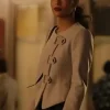 Thalia Besson as Geneviève in Emily in Paris S05 wearing a modern black asymmetric tailored jacket.