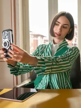 Lily Collins Emily in Paris green striped jacket with clean stripes and a smart look.