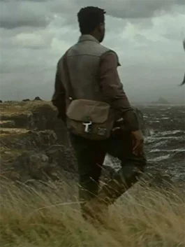 A men’s distressed brown utility vest with red shoulder accents and a weathered finish, inspired by Finn.