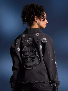 A women’s blue denim jacket featuring Star Wars embroidery on the back and custom metal buttons.