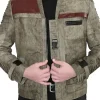 A man wearing a beige and brown jacket with red accents and ribbed sleeves, inspired by Finn.