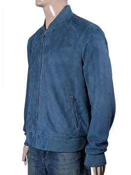 Actor Brad Pitt wearing a stylish blue suede bomber jacket with a rib-knitted collar and zipper closure from the F1 movie.