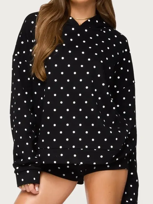 Front view of black Chelsie polka dot hoodie. Viral 2026 streetwear style with white spots and oversized fit.