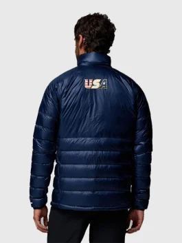 Back view of a man wearing a navy blue quilted jacket with the 
