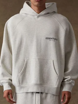 An oversized Fear of God Light Grey Hoodie with a minimalist streetwear design.