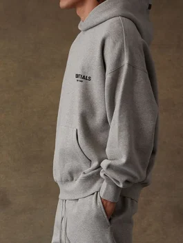 Close-up of the Essentials Grey Hoodie showing the signature logo branding.