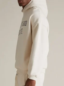 An Essentials Cream Hoodie featuring a soft fleece lining for extra warmth.