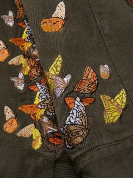 Detailed view of the Green Butterfly Work Jacket showing the intricate wing embroidery.