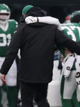 Front view of New York Jets black parka jacket showing zip closure, hood shape and clean winter style