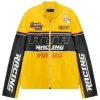 A yellow and black leather racing jacket with a black chest band featuring "RTA RACING." It includes "Grand Prix" patches and red "SPEED KILLS" text.