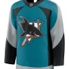 Front view of a teal hockey jersey featuring the classic shark biting a hockey stick logo, with grey and black curved sleeve panels.