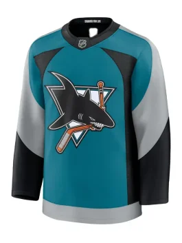 Front view of a teal hockey jersey featuring the classic shark biting a hockey stick logo, with grey and black curved sleeve panels.