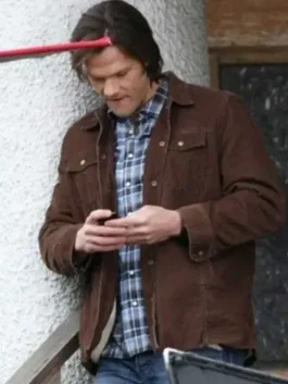 Brown Trucker Jacket side profile highlighting the precise sleeve stitching and adjustable waist tabs.