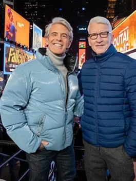 Andy Cohen blue puffer jacket from New Year's 2026 with a glossy electric blue finish and stand-up collar.