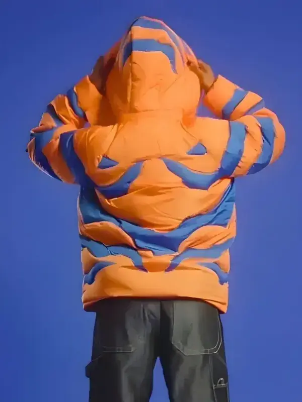 A vibrant Digimon Greymon Puffer Jacket in a bright orange shade with blue accents.