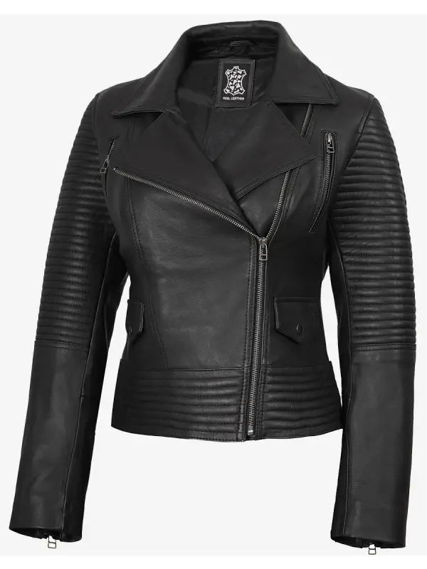 Close-up of snap and zipper pockets on a women's black leather biker jacket.