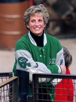 Close-up of rib-knitted collar and snap tab buttoned closure on the green wool Princess Diana Eagles jacket.