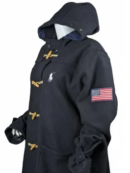 Close-up of the premium wool fabric, attached hood, and heritage toggle closure on the Team USA 2026 Olympic coat.