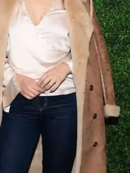 A stylish Bailee Madison Shearling Leather Coat featuring a secure button closure and oversized lapels.