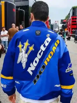 The back view of an Esteban Ocon Blue Nike Nocta Jacket showing large co-branded logos.