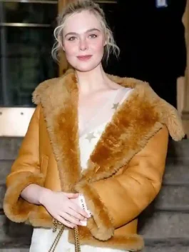 A stylish Elle Fanning Brown Shearling Jacket featuring a warm stand up collar and distressed finish.