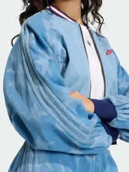 A professional shot of the blue Denim Graphic Varsity Bomber Jacket with a bold star pattern and athletic silhouette.