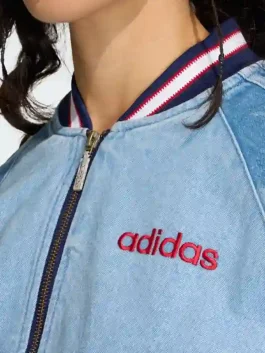A detailed close up of the Denim Graphic Varsity Bomber Jacket showing the star pattern accents and rib knitted collar.