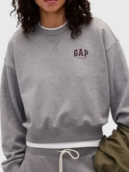 A woman wearing a premium French terry sweatshirt with a classic round neck.