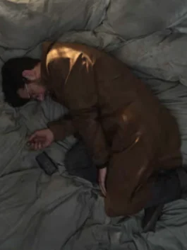 Close-up of the Hokum 2026 Adam Scott brown coat featuring a classic collar and button-down front