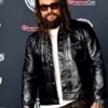 Jason Momoa wearing a sleek real leather jacket with front buttons and lapel collar.