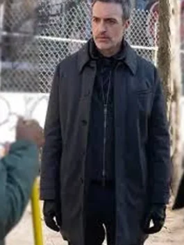 Close-up of a sophisticated wool coat with a soft inner lining and open hem cuffs.