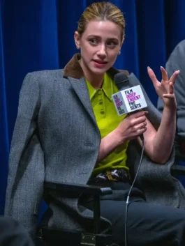 A woman in a professional grey blazer featuring a sophisticated suede-trimmed collar.