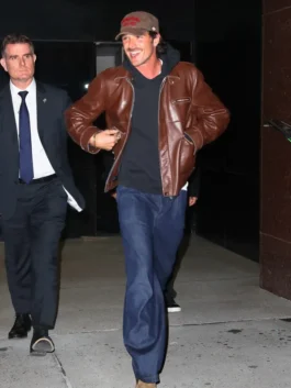 A man in a vintage-inspired leather jacket featuring dual front pockets and a zip closure.