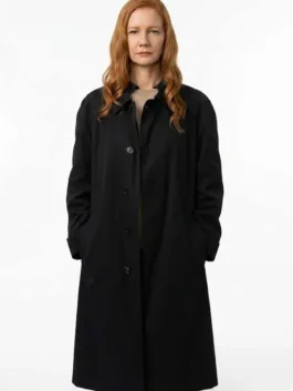 Eva Stratt long black trench coat with refined cinematic outerwear appeal.