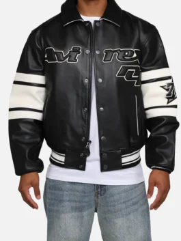 Model front view of AVIREX Brooklyn black leather bomber jacket with striped sleeves and ribbed trim
