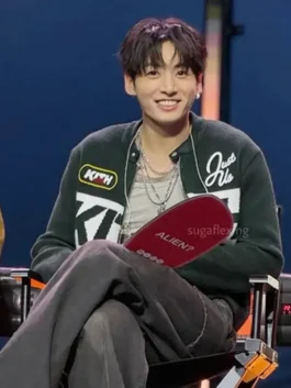 Jung Kook BTS jacket with sleek black outerwear look.