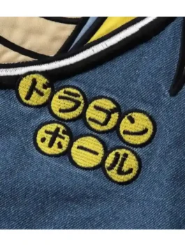 Close-up detail of Dragon Ball x BREEZE Denim Boa Jacket featuring yellow embroidered anime symbol patches on blue denim